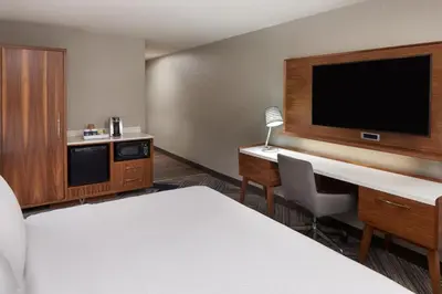 a room with a bed and a desk and a tv at Four Points by Sheraton Vaughan in Vaughan