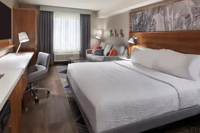 a hotel room with a bed and a couch at Four Points by Sheraton Vaughan in Vaughan