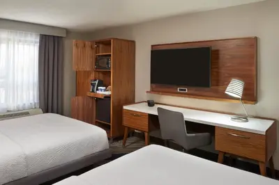 a hotel room with a desk and a bed at Four Points by Sheraton Vaughan in Vaughan