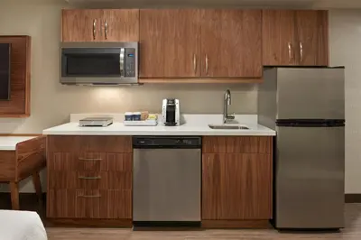 a kitchen with a sink and a refrigerator at Four Points by Sheraton Vaughan in Vaughan