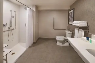 a bathroom with a toilet and a shower and a sink at Four Points by Sheraton Vaughan in Vaughan