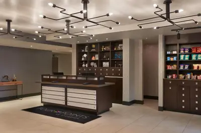 a dressing room with brown cabinets and shelves at Four Points by Sheraton Vaughan in Vaughan