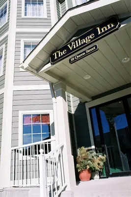 a building with a sign for the village library at The Village Inn of Lakefield in Lakefield