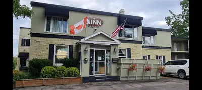 a inn with an american flag in front of it at The Inn At Lock Seven in Thorold