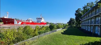 a large red ship is docked next to a building at The Inn At Lock Seven in Thorold