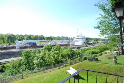 a park with a white bench in a field at The Inn At Lock Seven in Thorold