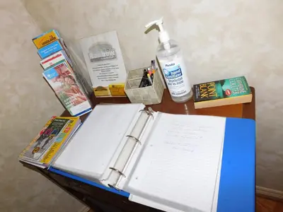 a table with a book and other items on it at Rainbow Bed & Breakfast in Niagara Falls