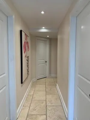 a hallway with a door and a tile floor at Lion's Head B&B in Niagara Falls