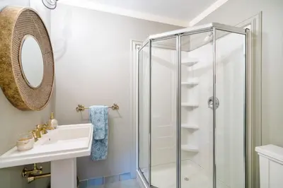 a bathroom with a shower and a sink at Lion's Head B&B in Niagara Falls