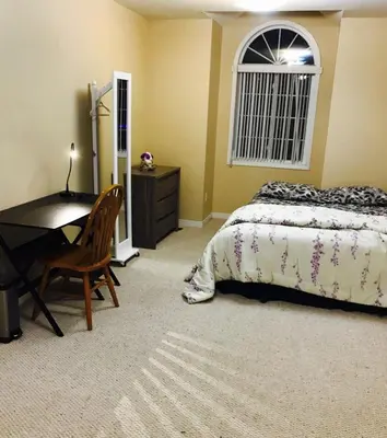 a bedroom with a bed and a desk and a table at Sweet dreams in Guelph