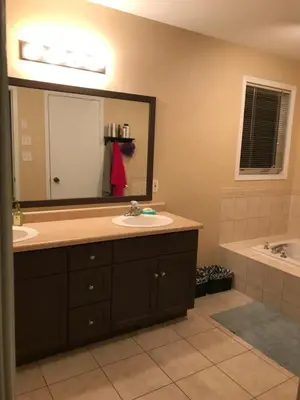 a bathroom with two sinks and a large mirror at Sweet dreams in Guelph