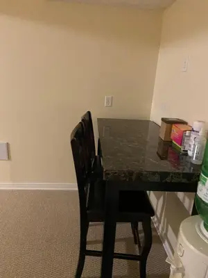 a desk with two chairs and a table with books on it at Sweet dreams in Guelph