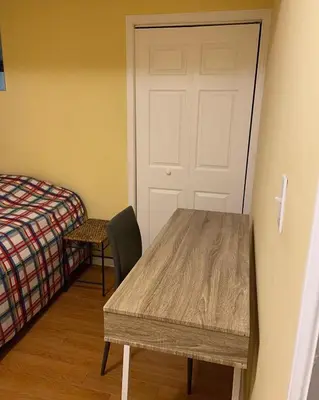 a room with a table and a door and a bed at Sweet dreams in Guelph