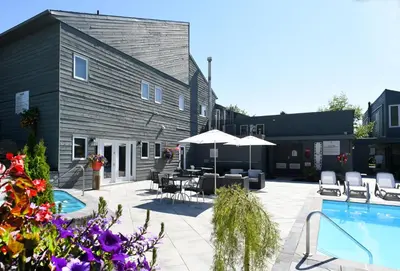 a patio with a pool and tables and chairs at Millcroft Inn & Spa in Alton