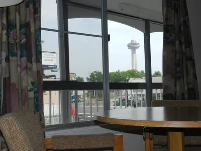 a room with a table and a view of a water tower at Kings Inn Near the Falls in Niagara Falls