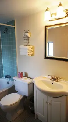 a bathroom with a toilet and a sink and a mirror at Kings Inn Near the Falls in Niagara Falls
