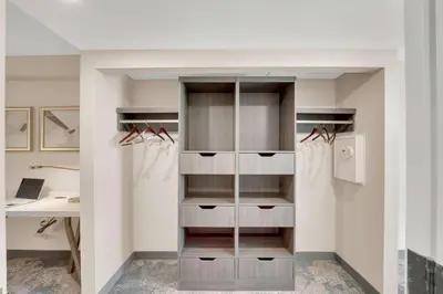 a closet with glass doors and a desk at Hilton Garden Inn Toronto/Brampton in Brampton