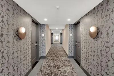 a corridor of a hotel hallway with doors and a carpet at Hilton Garden Inn Toronto/Brampton in Brampton