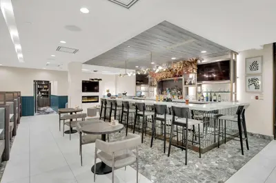 a bar in a restaurant with chairs and a counter at Hilton Garden Inn Toronto/Brampton in Brampton