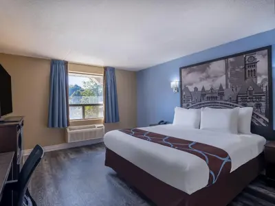 a hotel room with a large bed and a window at Super 8 by Wyndham Toronto East ON in Toronto