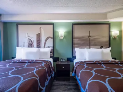 two beds in a room with green walls at Super 8 by Wyndham Toronto East ON in Toronto