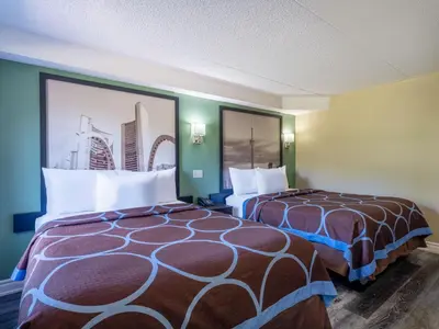 a hotel room with two beds in a room at Super 8 by Wyndham Toronto East ON in Toronto