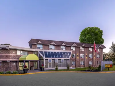 an exterior view of a hotel with a building at Super 8 by Wyndham Toronto East ON in Toronto