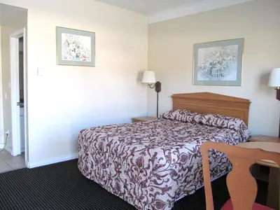 a hotel room with a bed and a desk at Knights Inn London Ontario in London