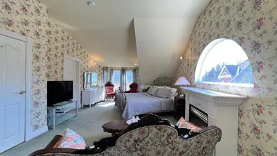a bedroom with a bed and a tv in a room at Bedham Hall B&B in Niagara Falls