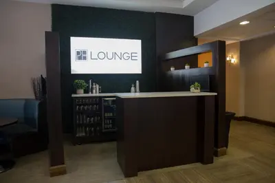 a bar in a office with a sign on a wall at The Park Hotel London in London