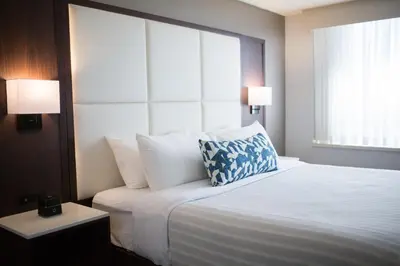 a hotel room with a bed with a pillow on it at The Park Hotel London in London