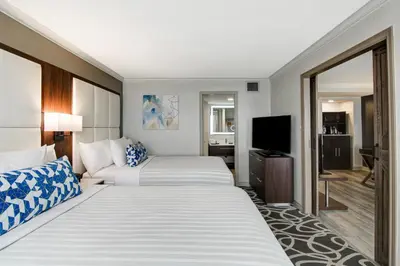 a hotel room with two beds and a television at The Park Hotel London in London