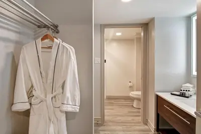 a bathroom with a white robe hanging on a rack at The Park Hotel London in London