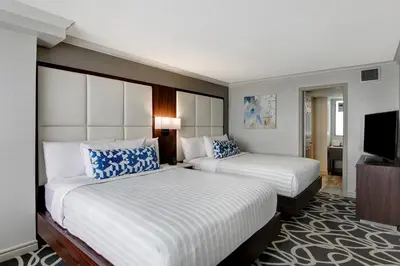 a hotel room with two beds and a flat screen tv at The Park Hotel London in London