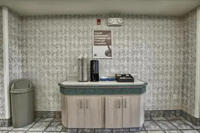 a coffee shop with a counter and a trash can at Motel 6-London, ON - Ontario in London