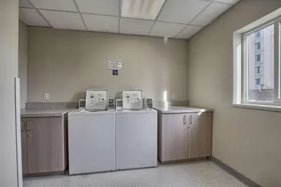 a room with two refrigerators and cabinets and a window at Motel 6-London, ON - Ontario in London