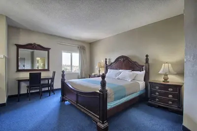 a bedroom with a bed and a desk and a mirror at Motel 6-London, ON - Ontario in London