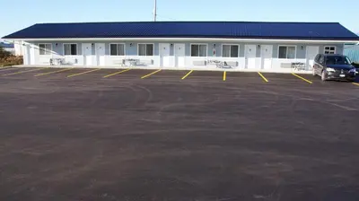 a parking lot in front of a building at Robyn's Motel in Peterborough