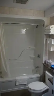 a bathroom with a tub and a toilet and a shower at Robyn's Motel in Peterborough