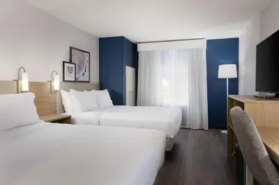 a hotel room with two beds and a tv at Spark By Hilton Guelph in Guelph