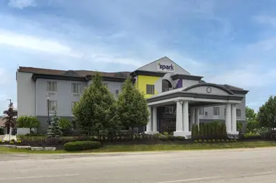a hotel with a yellow and white building at Spark By Hilton Guelph in Guelph