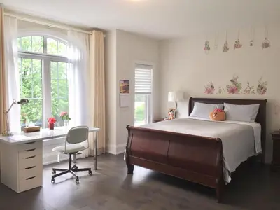 a bedroom with a bed and a desk and a chair at Comfortable private space in Pickering