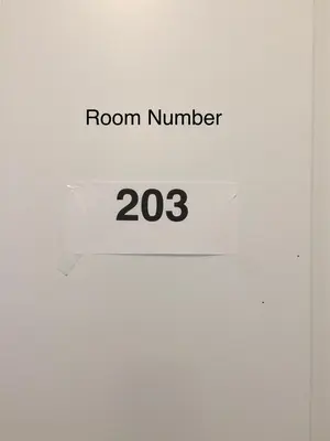 a room number sign on a white wall at Comfortable private space in Pickering