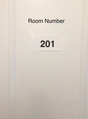 a white door with a room number on it at Comfortable private space in Pickering