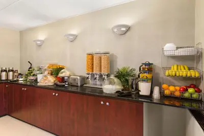a kitchen with a counter with fruits and vegetables at Travelodge by Wyndham Owen Sound ON in Owen Sound