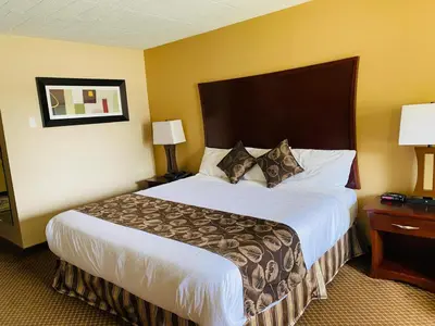 a hotel room with a large bed and two lamps at Luxury Inn in Collingwood