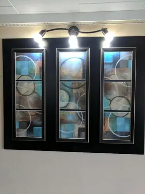 two stained glass windows on a wall with lights at Luxury Inn in Collingwood