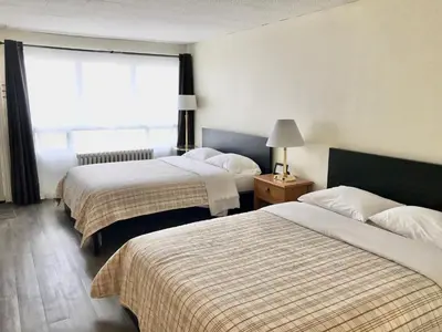 a hotel room with two beds and a window at Lakeside Inn in Orillia