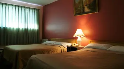 a hotel room with two beds and a lamp at Blue Jay Motel in Peterborough
