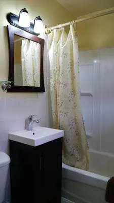 a bathroom with a sink and a shower curtain at Blue Jay Motel in Peterborough